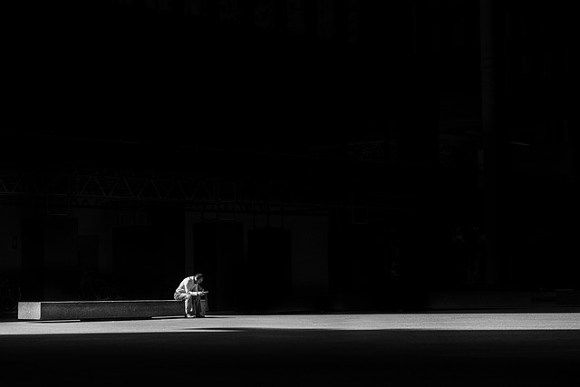 man sitting alone in the dark